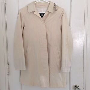 Soft pink Burberry trench coat with plaid checked hood and collar